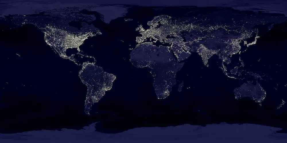 World map at night with dotted lights symbolizing global connectivity and BTS fandom around Cafe Magnate