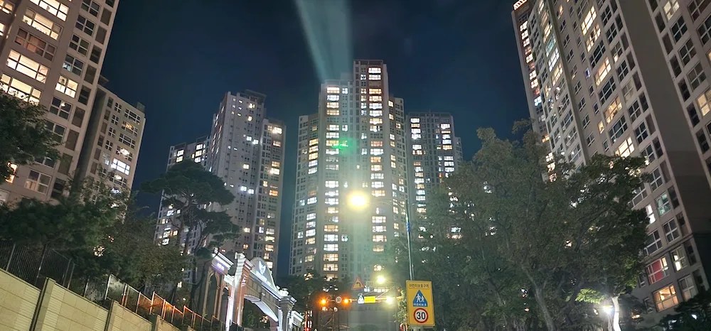Panoramic night view of a large 3,000-unit apartment complex near Cafe Magnate in Busan