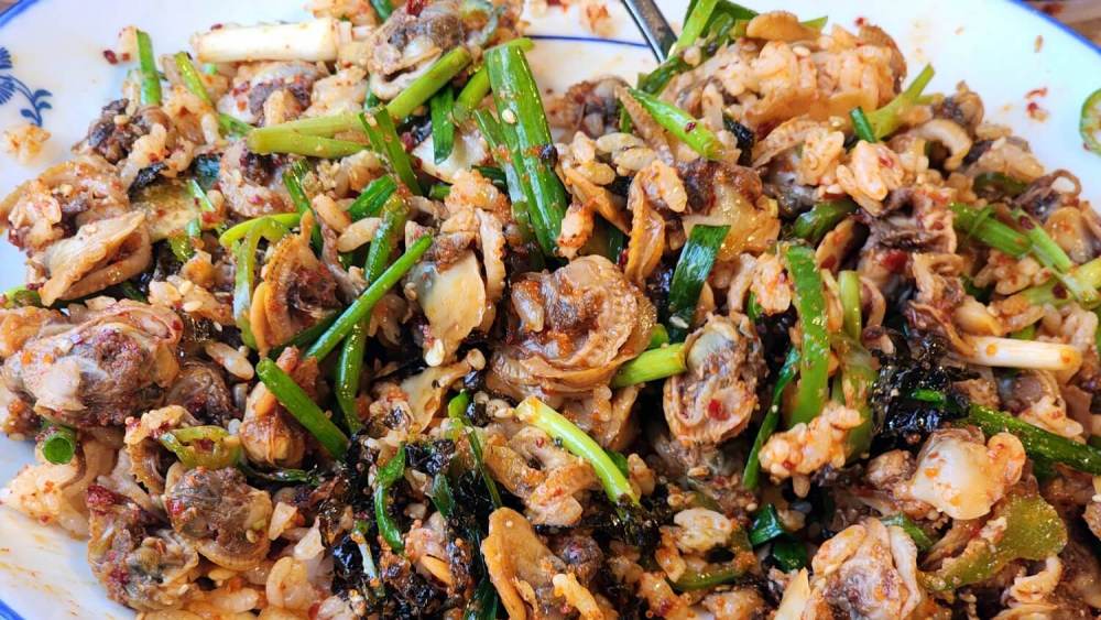 Spicy cockle salad (꼬막무침), a dish loved for its rich flavor, often considered a 밥도둑 (rice thief) in Korea.