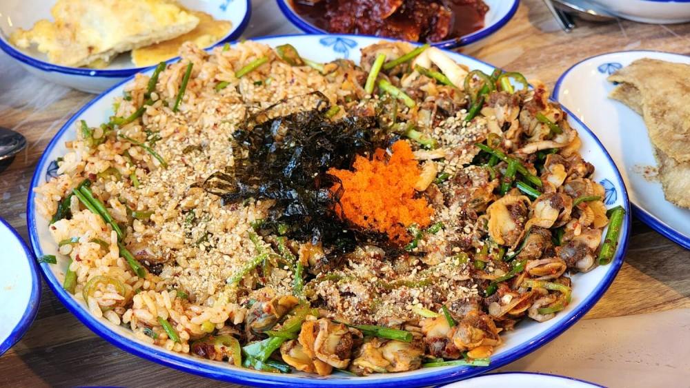 Spicy cockle salad (꼬막무침), a dish loved for its rich flavor, often considered a 밥도둑 (rice thief) in Korea.