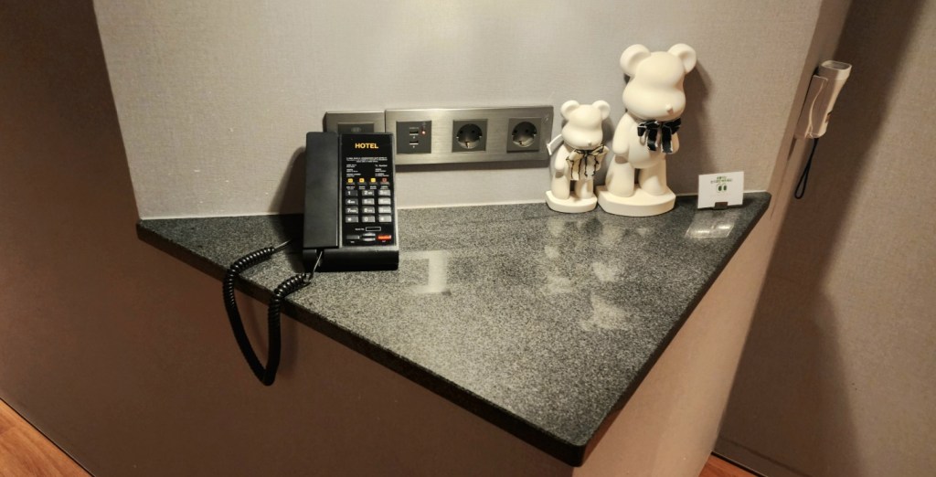 Cute corner in the hotel suite with an intercom phone and small bear figurines