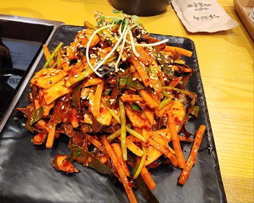 Spicy Korean seafood salad with vegetables and red pepper dressing