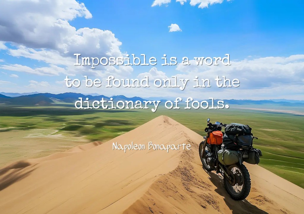Motivational quote by Napoleon Bonaparte: “Impossible is a word to be found only in the dictionary of fools,” shown with a lone motorbike on a mountain peak