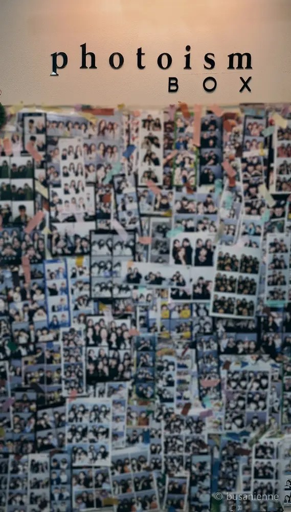 Photoism photo wall covered with photo strips in Busan | Nampo-dong photo booth culture