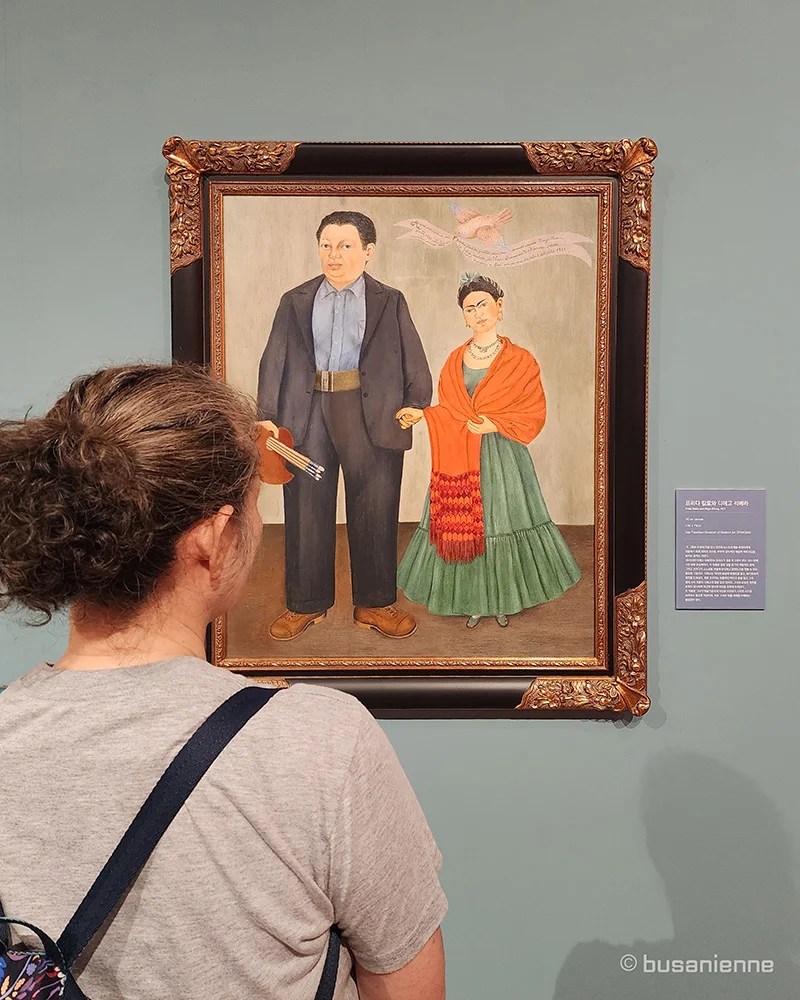 "Frida and Diego Rivera" (1931) serves as Frida Kahlo's early wedding portrait, painted two years into her tumultuous marriage with the famous Mexican muralist, Diego Rivera.